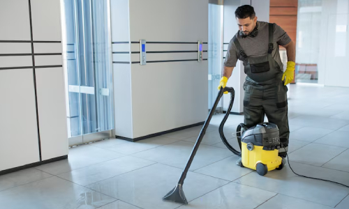 CT janitor cleaning marble floors in a commercial office building in high-traffic areas.